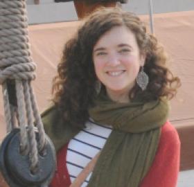 Carly Marino wearing a scarf and red sweater in a boat with ropes visible
