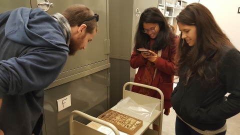 Interns examining items