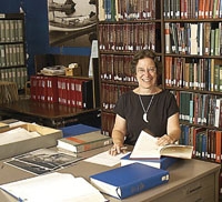 Joan Berman behind desk in library Special Collections